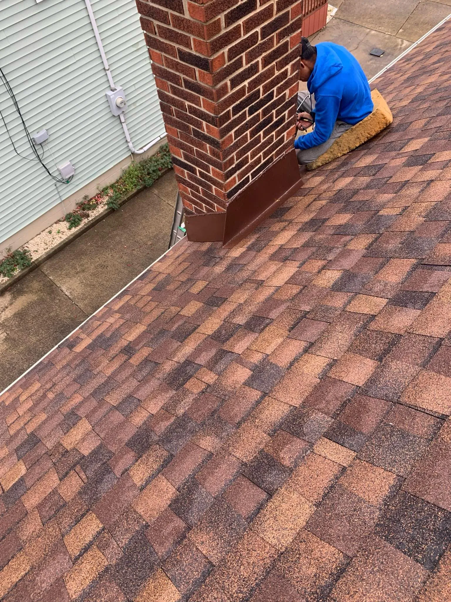 HOF Roofing technician nailing down architectural shingles during a roof repair in Ohio