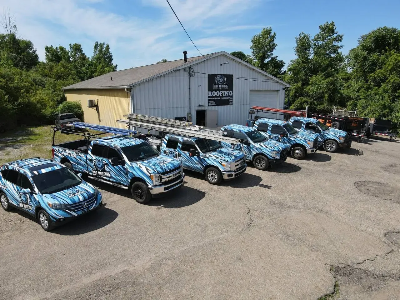 HOF Roofing wrapped fleet parked at the Northeast Ohio shop