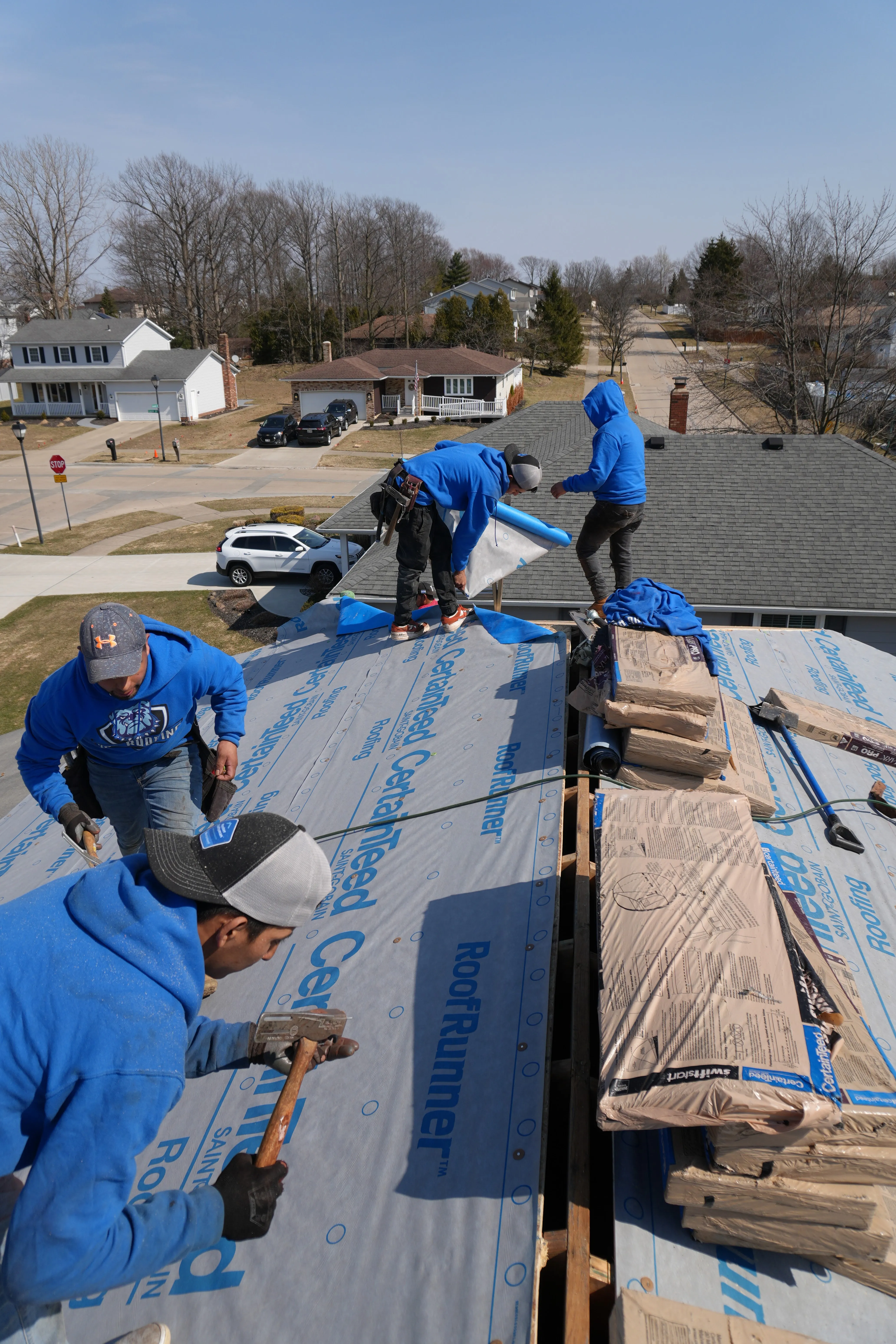 HOF Roofing crew replacing a storm-damaged roof using an Equipter to protect the property in Ohio